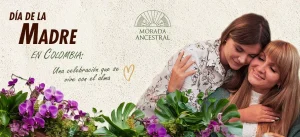 Madre e hija abrazadas con flores, celebración del Día de la Madre en Colombia